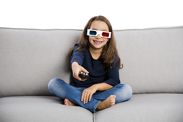 Image showing Girl holding a TV remote