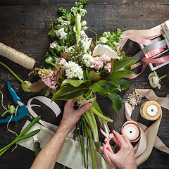 Image showing The florist desktop with working tools and ribbons