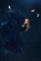 Image showing The young beautiful modern dancer dancing under water drops