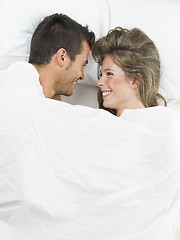 Image showing attractive couple in love under white bed sheets