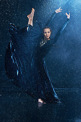 Image showing The young beautiful modern dancer dancing under water drops