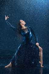 Image showing The young beautiful modern dancer dancing under water drops