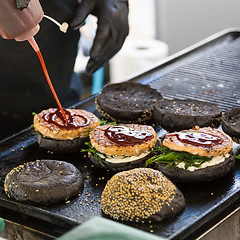 Image showing Beef burgers ready to serve on food stall.