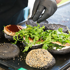 Image showing Beef burgers ready to serve on food stall.