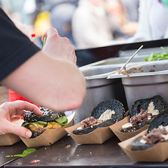 Image showing Beef burgers ready to serve on food stall.