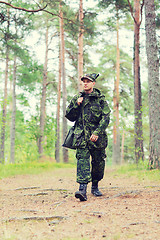 Image showing young soldier or hunter with gun in forest