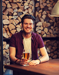 Image showing happy man drinking beer at bar or pub