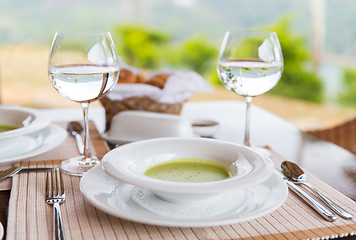 Image showing close up of soup and water glasses at restaurant