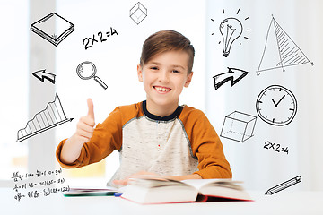 Image showing happy student boy with textbook showing thumbs up