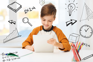 Image showing smiling boy with tablet pc and notebook at home