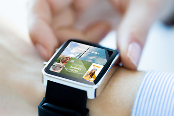 Image showing close up of hands with application on smartwatch
