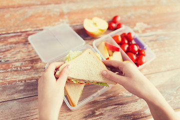 Image showing close up of woman with food in plastic container