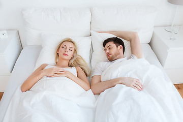 Image showing happy couple sleeping in bed at home