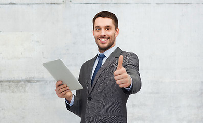 Image showing young businessman with tablet pc showing thumbs up