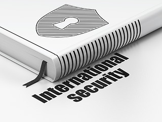 Image showing Safety concept: book Shield With Keyhole, International Security on white background