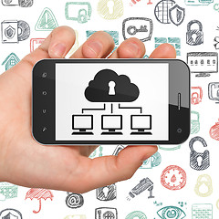 Image showing Protection concept: Hand Holding Smartphone with Cloud Network on display