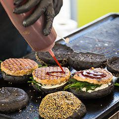 Image showing Beef burgers ready to serve on food stall.