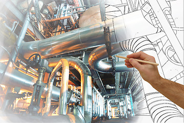 Image showing man\'s hand draws a design of factory combined with photo of mode
