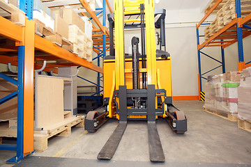 Image showing Forklift, shelves and racks with pallets in distribution warehou