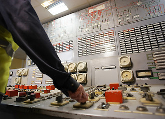 Image showing Hand on the control panel of a power plant