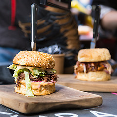 Image showing Beef burgers being served on street food stall