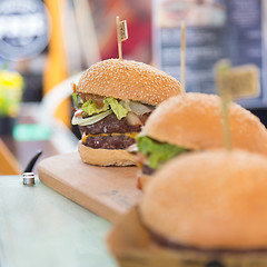 Image showing Beef burgers being served on street food stall