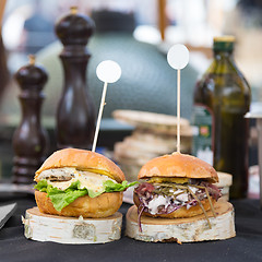 Image showing Beef burgers being served on street food stall