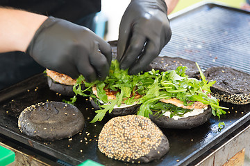 Image showing Beef burgers ready to serve on food stall.