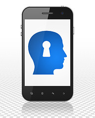 Image showing Advertising concept: Smartphone with Head With Keyhole on display