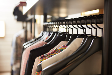 Image showing Clothes on hangers in shop.