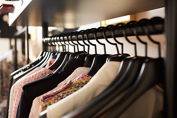 Image showing Clothes on hangers in shop.