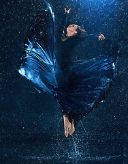 Image showing The young beautiful modern dancer dancing under water drops