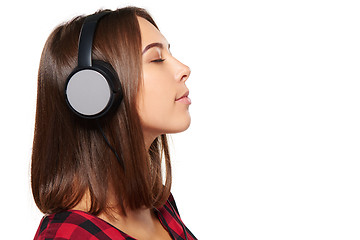 Image showing Female listening enjoying music in headphones with closed eyes