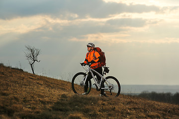 Image showing Man cyclist with backpack riding the bicycle