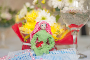 Image showing Spring doll with red heart in hands