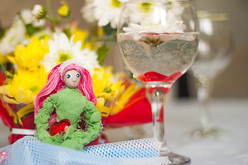 Image showing Spring doll with red heart in hands