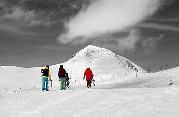 Image showing Three snowboarder on slope. Selective color.