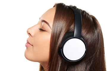 Image showing Female listening enjoying music in headphones with closed eyes