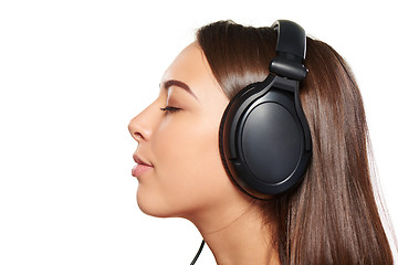 Image showing Female listening enjoying music in headphones with closed eyes