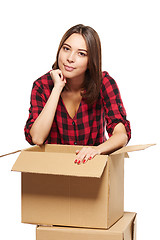 Image showing Young woman with cardboard boxes