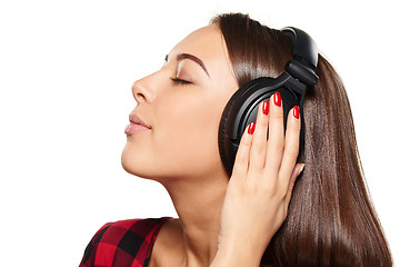 Image showing Female listening enjoying music in headphones with closed eyes