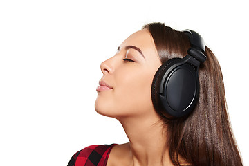 Image showing Female listening enjoying music in headphones with closed eyes