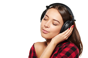 Image showing Female listening enjoying music in headphones with closed eyes