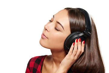 Image showing Female listening enjoying music in headphones with closed eyes