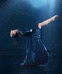 Image showing The young beautiful modern dancer dancing under water drops