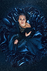 Image showing The young beautiful modern dancer dancing under water drops