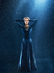 Image showing The young beautiful modern dancer dancing under water drops