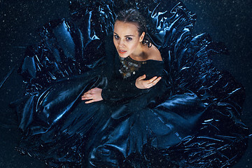 Image showing The young beautiful modern dancer posing under water drops