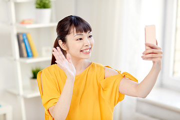 Image showing happy asian woman taking selfie with smartphone