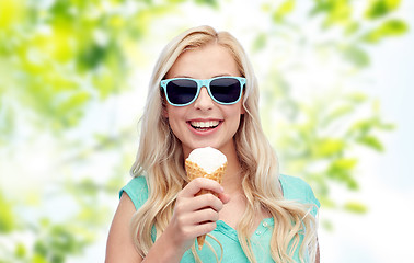 Image showing happy young woman in sunglasses eating ice cream